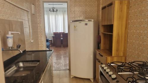 uma cozinha com um frigorífico branco e um fogão em Apartamento 3 quartos em Copacabana no Rio de Janeiro