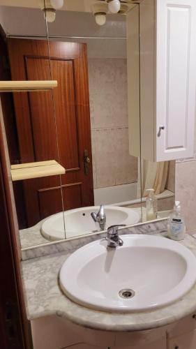 a bathroom counter with a sink and a mirror at Happyhouse in Algueirão - Mem Martins