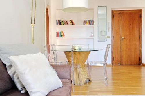 uma sala de estar com uma mesa e um sofá em Confortevole appartamento vicino Ponte Milvio em Roma