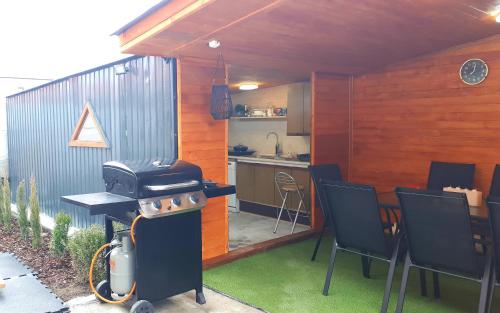 a patio with a grill and a table and chairs at Penzión Florens, Nesvady in Nesvady