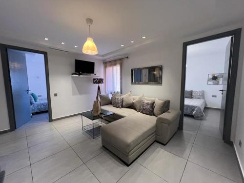 a living room with a couch and a table at AiM HOUSE in Marrakech
