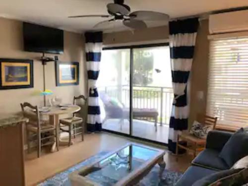 a living room with a couch and a table at Beachfront Condo with Ocean View in Hilton Head Island