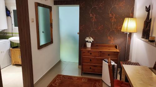 a bathroom with a mirror and a wooden dresser at Andy's Apartman in Budapest