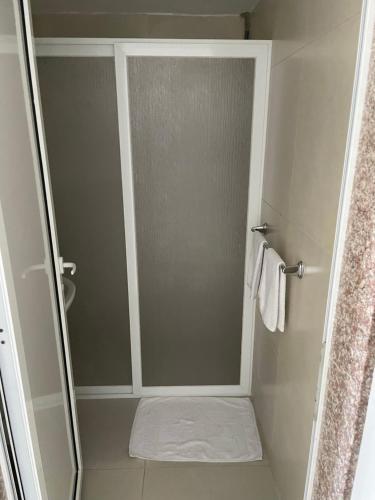 a shower with a glass door in a bathroom at Golden Stone Beach 