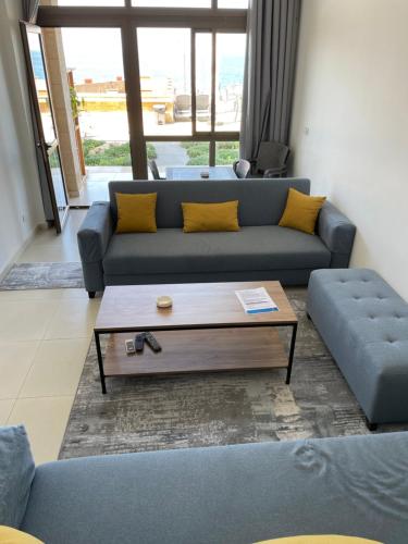 a living room with a couch and a coffee table at Golden Stone Beach in Halat Byblos