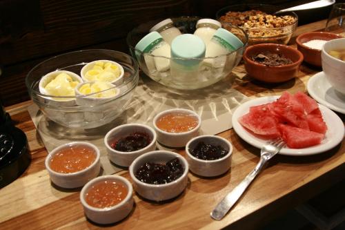 a table topped with bowls of different types of food at Kaulem Hotel Boutique in El Chalten