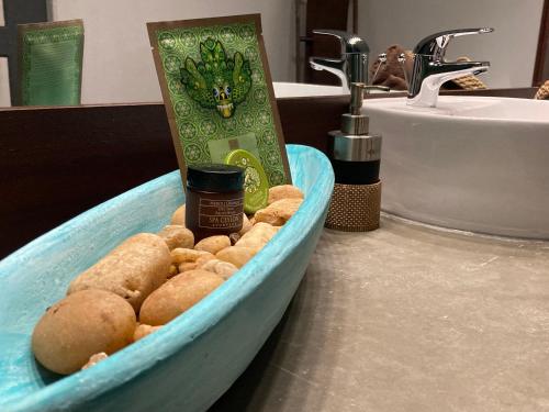 a container of food sitting on a sink in a bathroom at The Villa Green Inn in Negombo