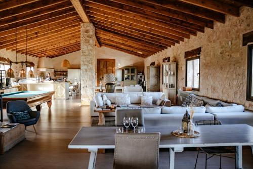 a living room with couches and a pool table at Finca Gomera - Agroturismo Hotel in Cala Pi