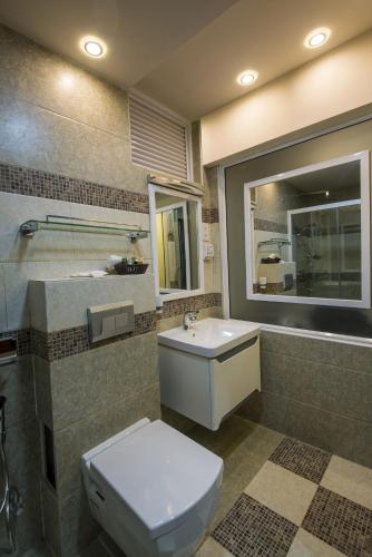 a bathroom with a toilet and a sink at Vista Beach Retreat in Hulhumale