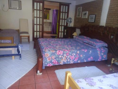 a bedroom with two beds and a couch at Chez Marine Guest House in Búzios