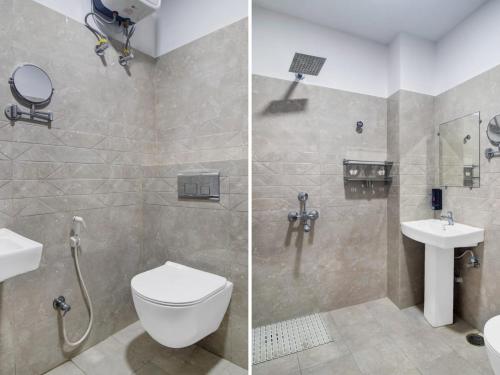 a bathroom with a shower and a toilet and a sink at THE SUPERB HOTEL PVT LTD in Hyderabad