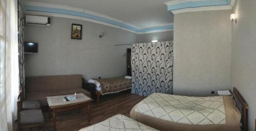 a living room with two beds and a couch at Emil Motel in Kürdǝmir
