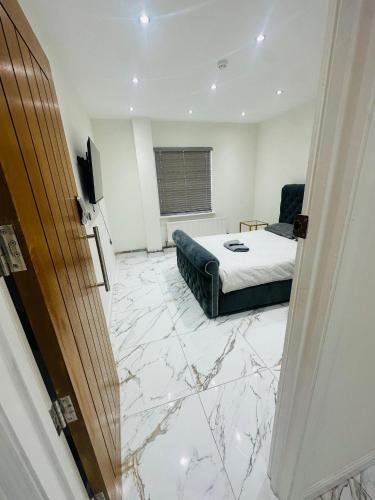 a bedroom with a bed and a television in a room at KNIGHTSBRIDGE COURT in Horninglow