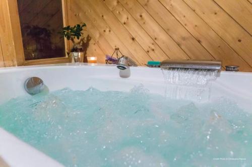 a bath tub with water coming out of it at Joli Chalet Savoyard in Val-d'Isère