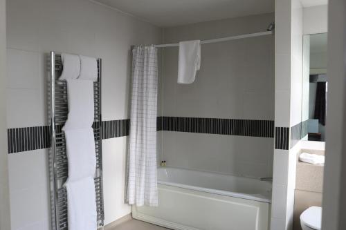 a bathroom with a shower with a glass door at Fairway Inn in Manchester