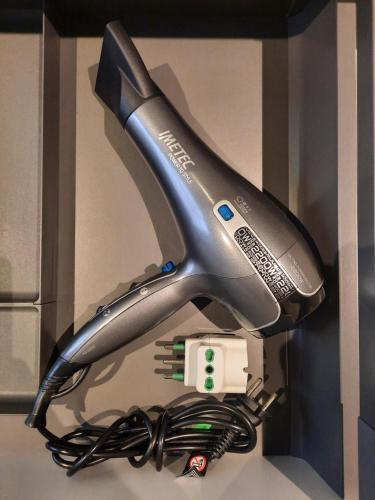 a hair dryer in a box with a bundle of cords at Aosta Holiday Apartments - Sant'Anselmo in Aosta