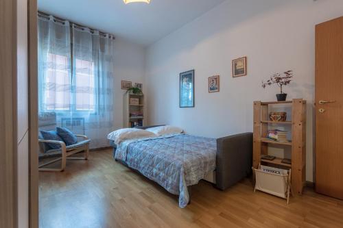 um quarto com uma cama e uma cadeira em Bologna City Retreat a due passi dalla Fiera em Bolonha