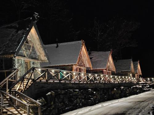 a row of houses in the snow at night at Vikings Villages Resort in Guilford