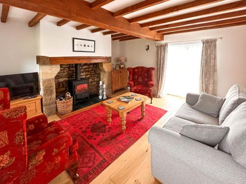 a living room with a couch and a fireplace at A D Barn in Fremington
