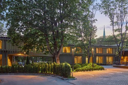 a large tree in front of a building at Monist Palanga boutique by SPA VILNIUS in Palanga