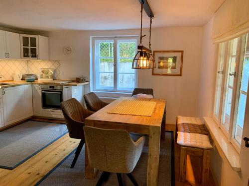 a kitchen with a wooden table and a dining room at Ferienwohnung Prinzenhöhe in Herrsching am Ammersee