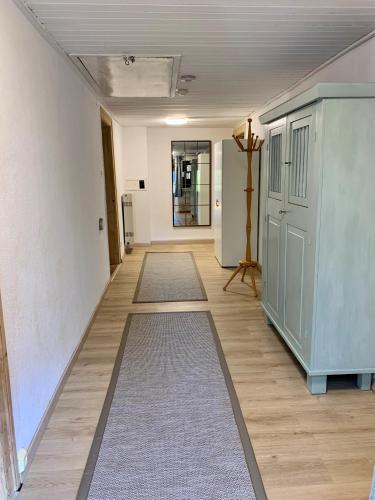 a hallway with rugs on the floor of a room at Ferienwohnung Prinzenhöhe in Herrsching am Ammersee