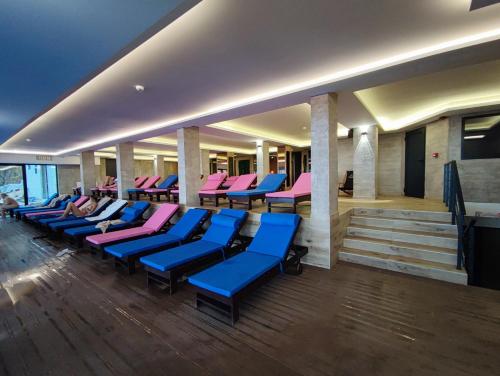 a row of blue and pink chairs in a building at Milmari L29 in Kopaonik