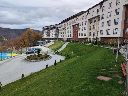 a building with a basketball court in front of a building at Milmari L29 in Kopaonik