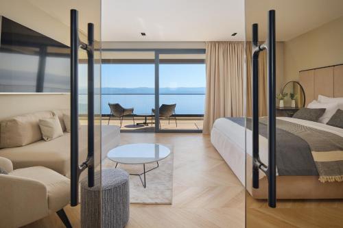 a bedroom with a bed and a living room at Villa Mirabel in Mimice