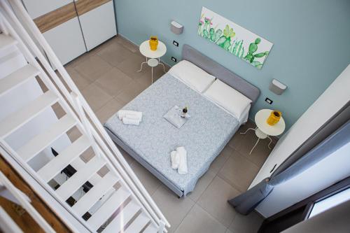 an overhead view of a bedroom with a bed and two tables at Ruggero Settimo - Holiday Houses in Catania