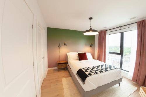 a bedroom with a bed and a green wall at The Laundry Rooms - Waterloo in Waterloo