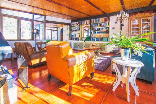 uma sala de estar com um sofá de couro e uma mesa em Hotel Rural El Refugio em Tejeda