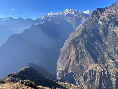 a mountain with a lake in the middle at the wooden house choquequirao in Cachora