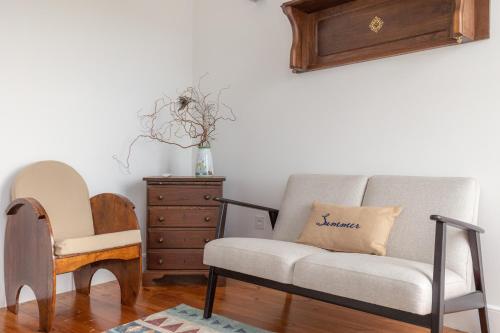 a living room with a couch and a chair at Casas da Couraça in Coimbra