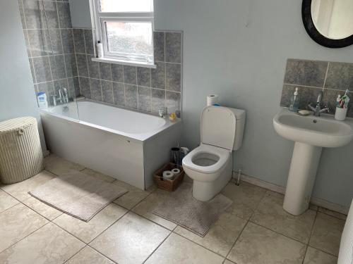 a bathroom with a tub and a toilet and a sink at 123a Antrim Road in Belfast