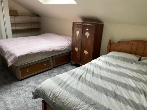 a bedroom with two beds and a dresser at 123a Antrim Road in Belfast