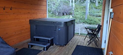 a porch with a stove and a chair on a deck at Tapio in Syöte