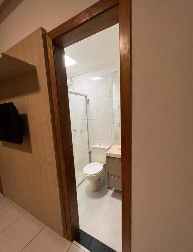 a bathroom with a toilet and a glass door at Casa Maravilhosa em condominio in Luis Eduardo Magalhaes