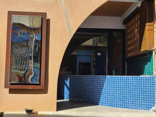 an entrance to a building with a blue tile wall at 覓思旅Miss inn in Hengchun South Gate