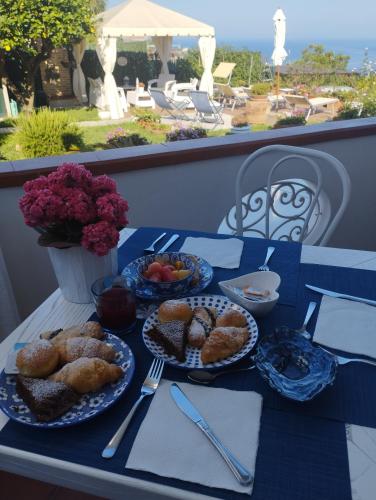 a blue table with plates of food on it at B&B Villa Cristina in Anacapri