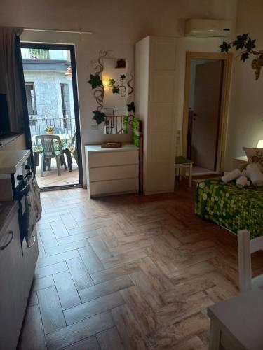 a living room with a wooden floor and a living room at Antico Borgo - A due passi dalle Gole Alcantara in Motta Camastra