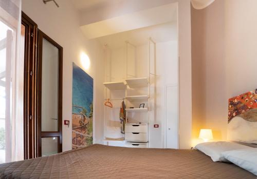 a bedroom with a bed and a closet at Kòre rooms in Castellammare del Golfo
