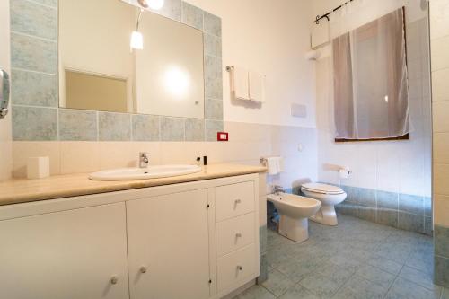 a bathroom with a sink and a toilet at Kòre rooms in Castellammare del Golfo