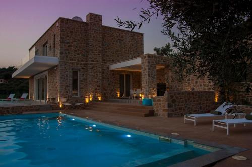 una casa con piscina frente a ella en White Pearl Golf Villa, en Gialova