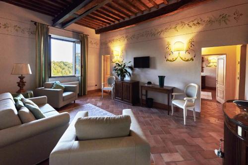 a living room with a couch and a table at Villa Curina Resort in Castelnuovo Berardenga