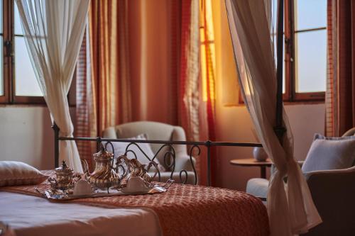 a bedroom with a bed with a tray of food on it at Villa Curina Resort in Castelnuovo Berardenga