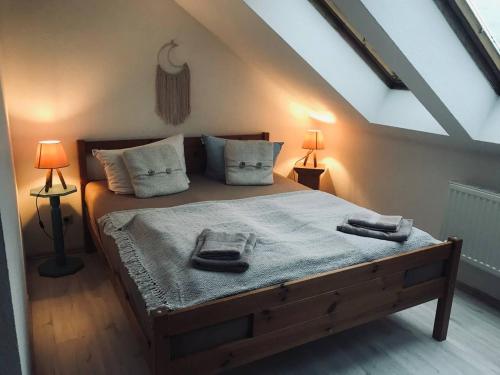 a bedroom with a large bed with two lamps at Ferienwohnung Naturparadies Gnitz in Lütow