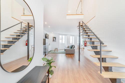 a staircase in a living room with a mirror at Ajuda Deluxe Apartments in Lisbon