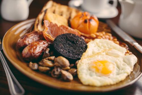 a plate of food with eggs and nuts on a table at The Stables - The Inn Collection Group in Whitby