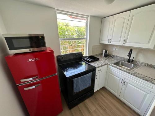 a kitchen with a red refrigerator and a microwave at Stylish Studio Brickell/Little Havana@ItalianPlaza in Miami